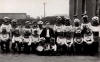 Lord Gordon Parry at the school again, this time as the class teacher in the middle of the picture, surrounded by his Black & White Minstrels. This photo would date to around 19xx.